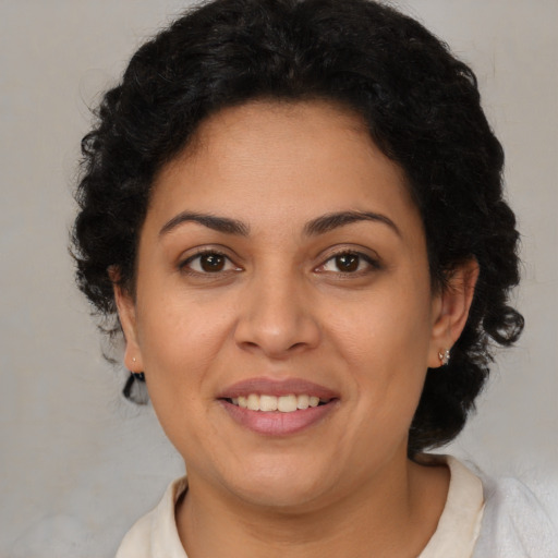 Joyful latino young-adult female with short  brown hair and brown eyes