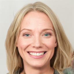 Joyful white adult female with long  brown hair and blue eyes