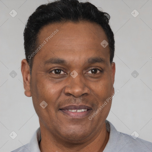 Joyful latino adult male with short  black hair and brown eyes
