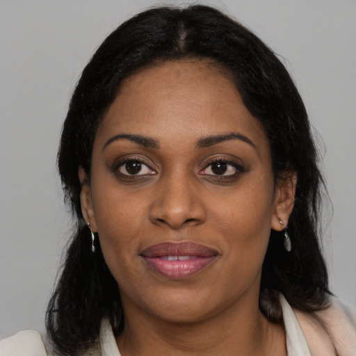 Joyful black young-adult female with medium  black hair and brown eyes
