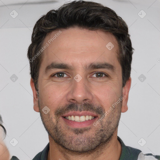 Joyful white adult male with short  brown hair and brown eyes