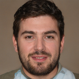 Joyful white young-adult male with short  black hair and brown eyes