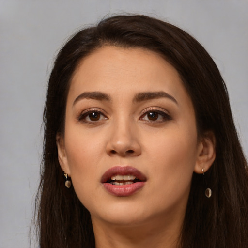 Joyful white young-adult female with long  brown hair and brown eyes