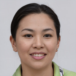 Joyful asian young-adult female with short  brown hair and brown eyes