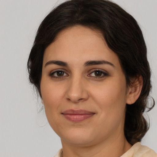 Joyful white young-adult female with medium  brown hair and brown eyes