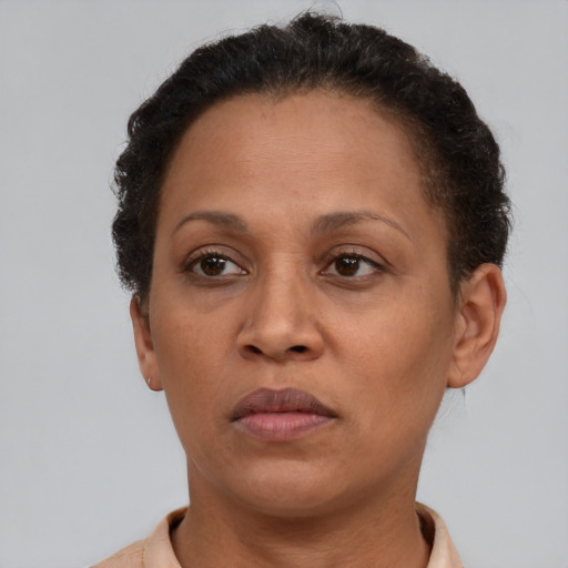 Neutral latino adult female with short  brown hair and brown eyes