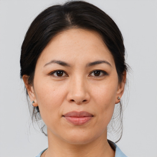 Joyful asian adult female with medium  brown hair and brown eyes