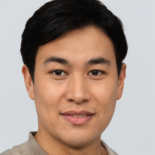 Joyful asian young-adult male with short  brown hair and brown eyes