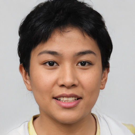 Joyful asian young-adult female with short  black hair and brown eyes