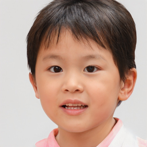 Joyful asian child female with short  brown hair and brown eyes