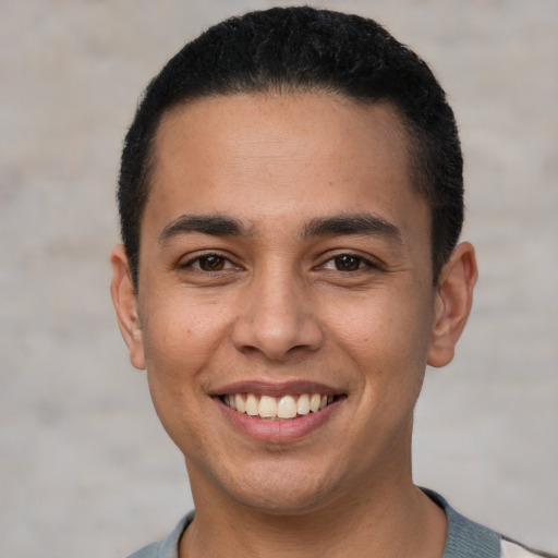 Joyful white young-adult male with short  black hair and brown eyes