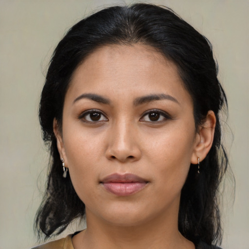 Joyful latino young-adult female with medium  brown hair and brown eyes