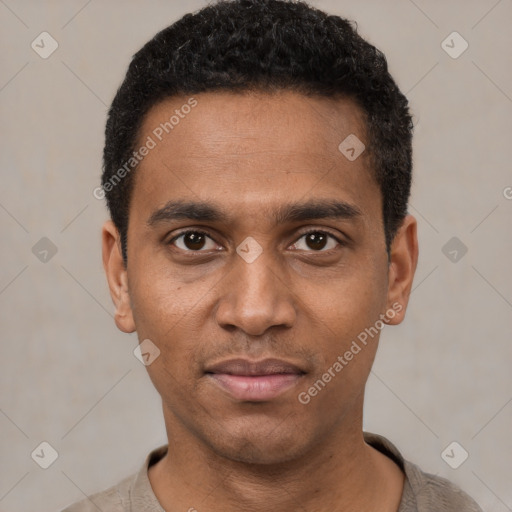 Joyful black young-adult male with short  black hair and brown eyes