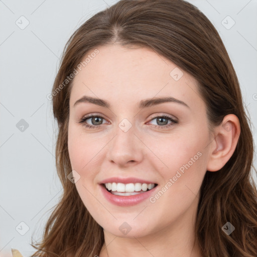 Joyful white young-adult female with long  brown hair and blue eyes