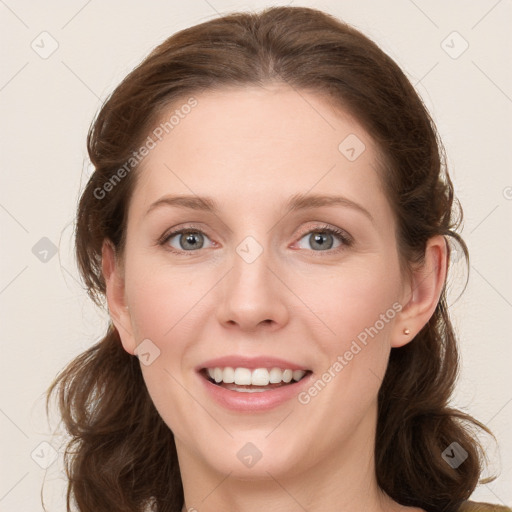 Joyful white young-adult female with long  brown hair and blue eyes