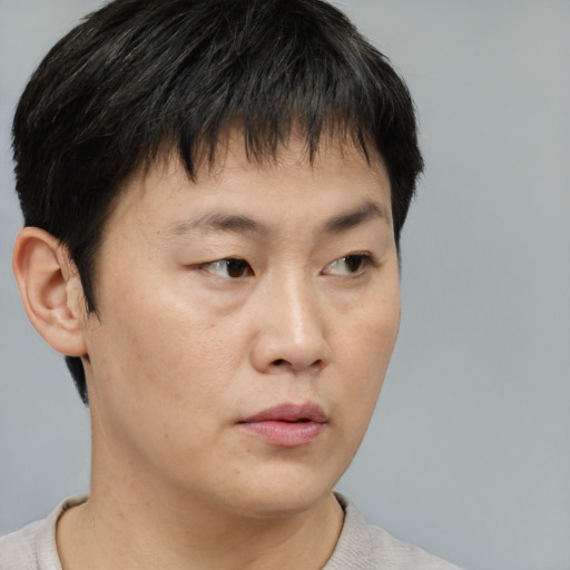 Neutral asian young-adult male with short  brown hair and brown eyes