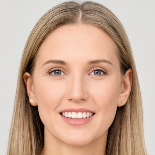 Joyful white young-adult female with long  brown hair and grey eyes