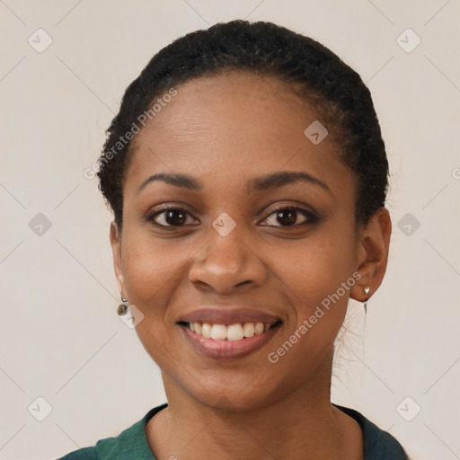 Joyful black young-adult female with short  black hair and brown eyes