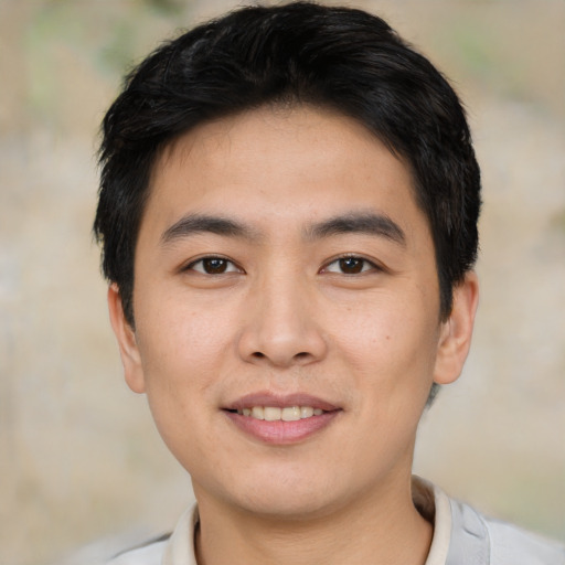 Joyful asian young-adult male with short  brown hair and brown eyes