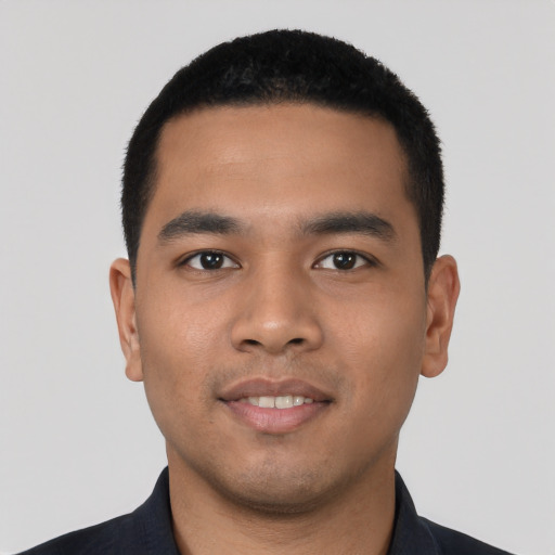 Joyful latino young-adult male with short  black hair and brown eyes