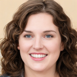 Joyful white young-adult female with medium  brown hair and green eyes