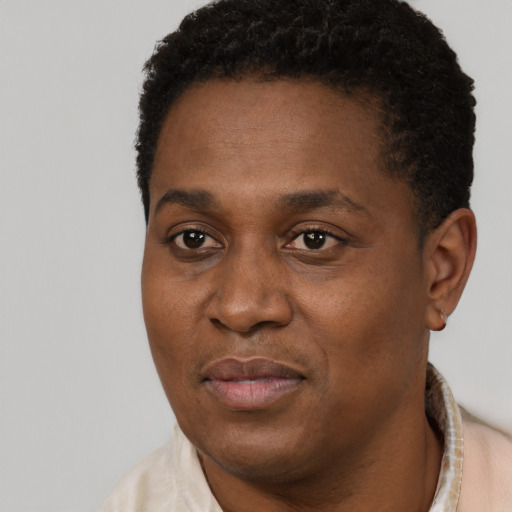 Joyful black adult male with short  black hair and brown eyes