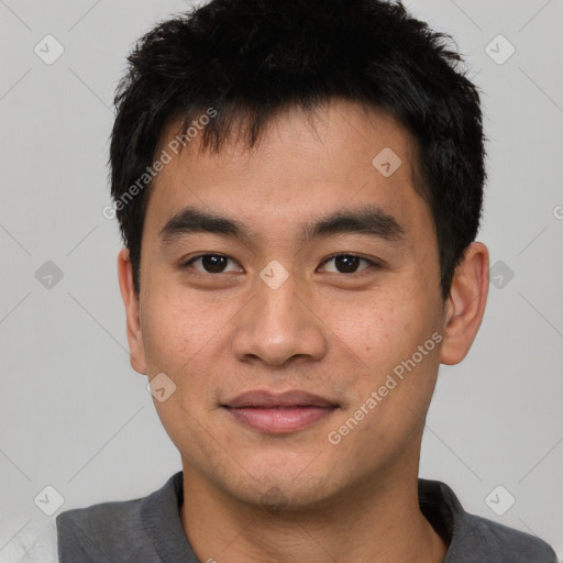 Joyful asian young-adult male with short  black hair and brown eyes