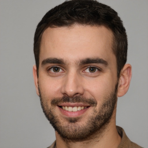 Joyful white young-adult male with short  brown hair and brown eyes