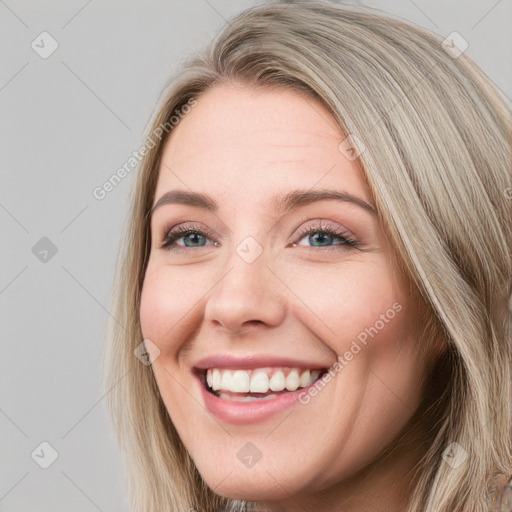 Joyful white young-adult female with long  brown hair and blue eyes