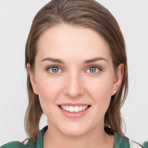 Joyful white young-adult female with medium  brown hair and green eyes