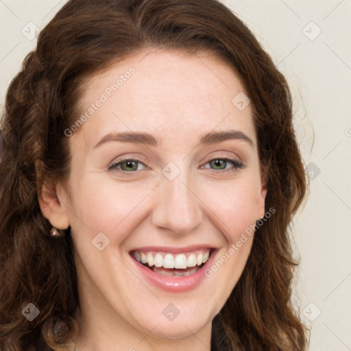 Joyful white young-adult female with long  brown hair and green eyes