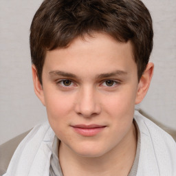 Joyful white child male with short  brown hair and brown eyes