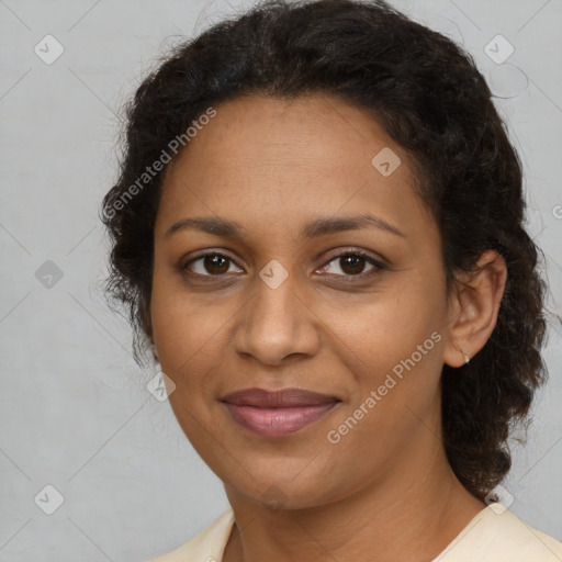 Joyful black adult female with medium  brown hair and brown eyes