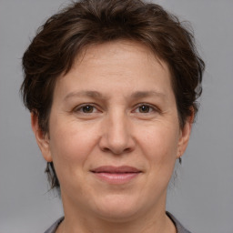 Joyful white adult female with short  brown hair and brown eyes