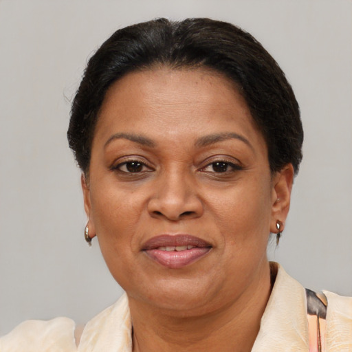 Joyful latino adult female with short  brown hair and brown eyes