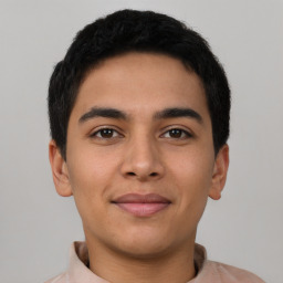 Joyful latino young-adult male with short  brown hair and brown eyes