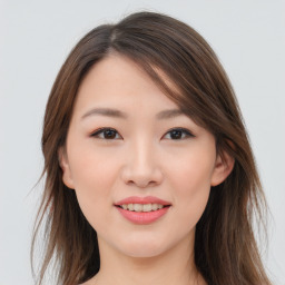 Joyful asian young-adult female with long  brown hair and brown eyes