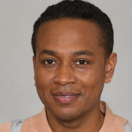 Joyful latino adult male with short  black hair and brown eyes