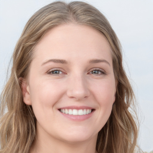 Joyful white young-adult female with long  brown hair and blue eyes