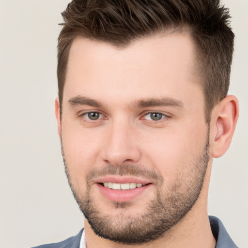 Joyful white young-adult male with short  brown hair and brown eyes