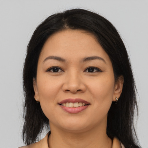 Joyful asian young-adult female with long  brown hair and brown eyes