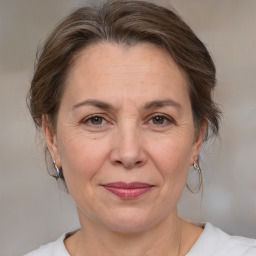 Joyful white adult female with medium  brown hair and brown eyes