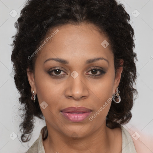 Joyful black adult female with medium  brown hair and brown eyes