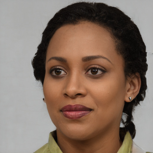 Joyful black young-adult female with medium  brown hair and brown eyes