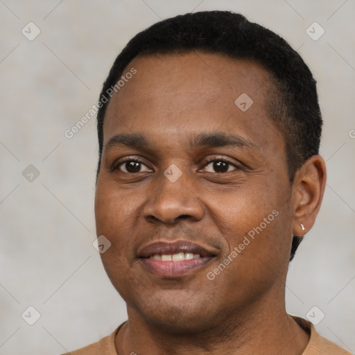 Joyful black young-adult male with short  black hair and brown eyes