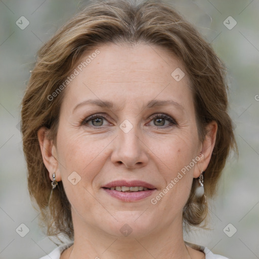 Joyful white adult female with medium  brown hair and grey eyes