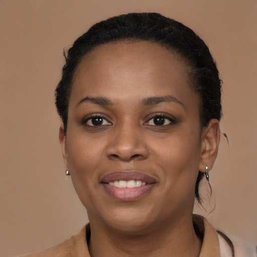 Joyful black young-adult female with short  brown hair and brown eyes