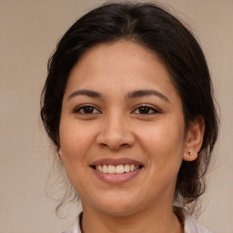 Joyful latino young-adult female with medium  brown hair and brown eyes