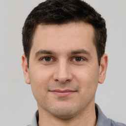 Joyful white young-adult male with short  brown hair and brown eyes