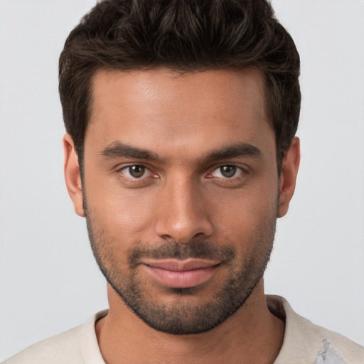 Joyful white young-adult male with short  brown hair and brown eyes